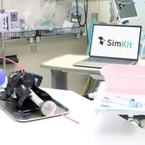 Jason Hine presenting the SimKit emergency medicine model, highlighting its hands-on training features in a professional setting.